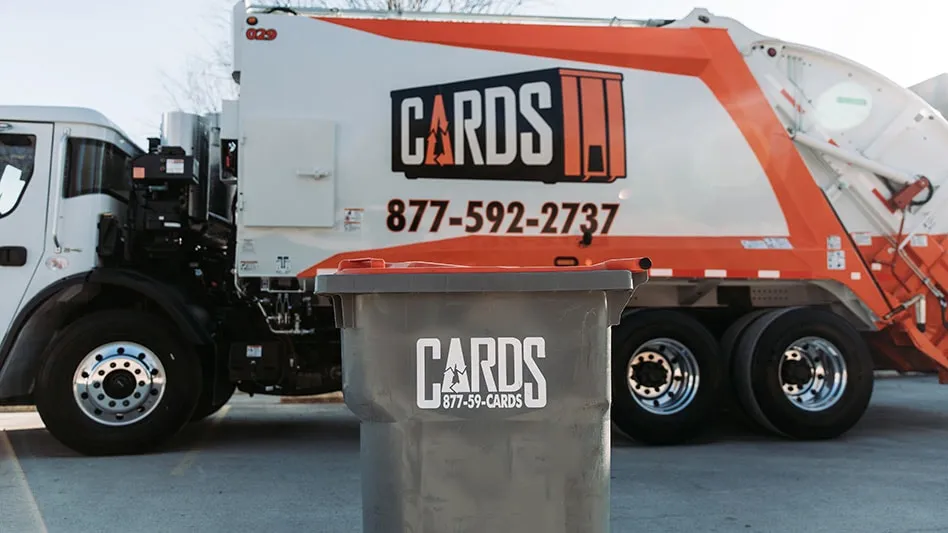 a cards truck in the background with a cards collection container in the foreground