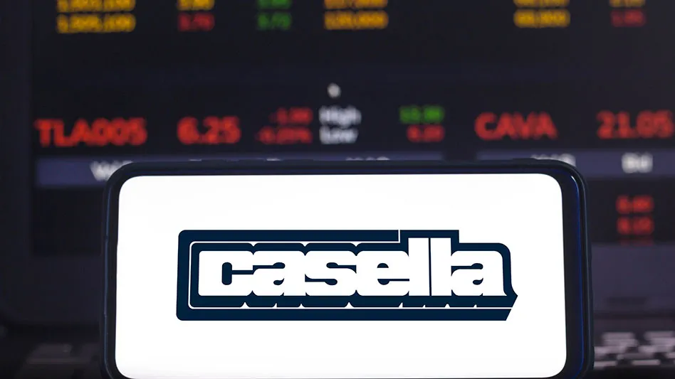 casella logo in front of stock trading board